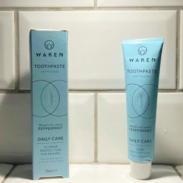 waken toothpaste tube next to it's packaging